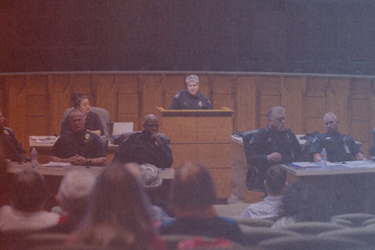 A police officer is hosting a meeting in the City of Aurora