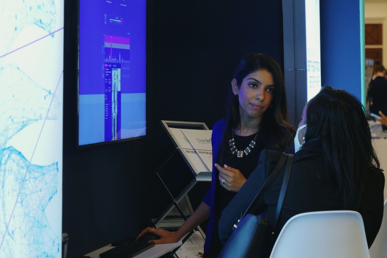 Cleerly executive member collaborate with attendees at healthcare conference