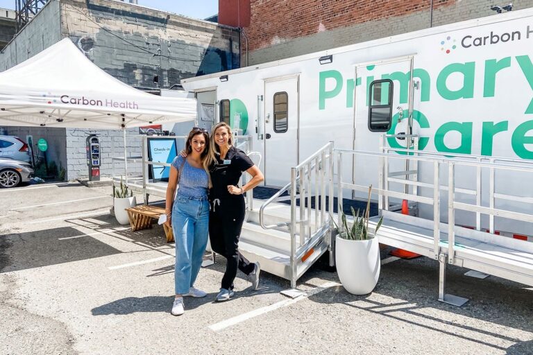 Carbon Health staff collaborate on site in the parking lot