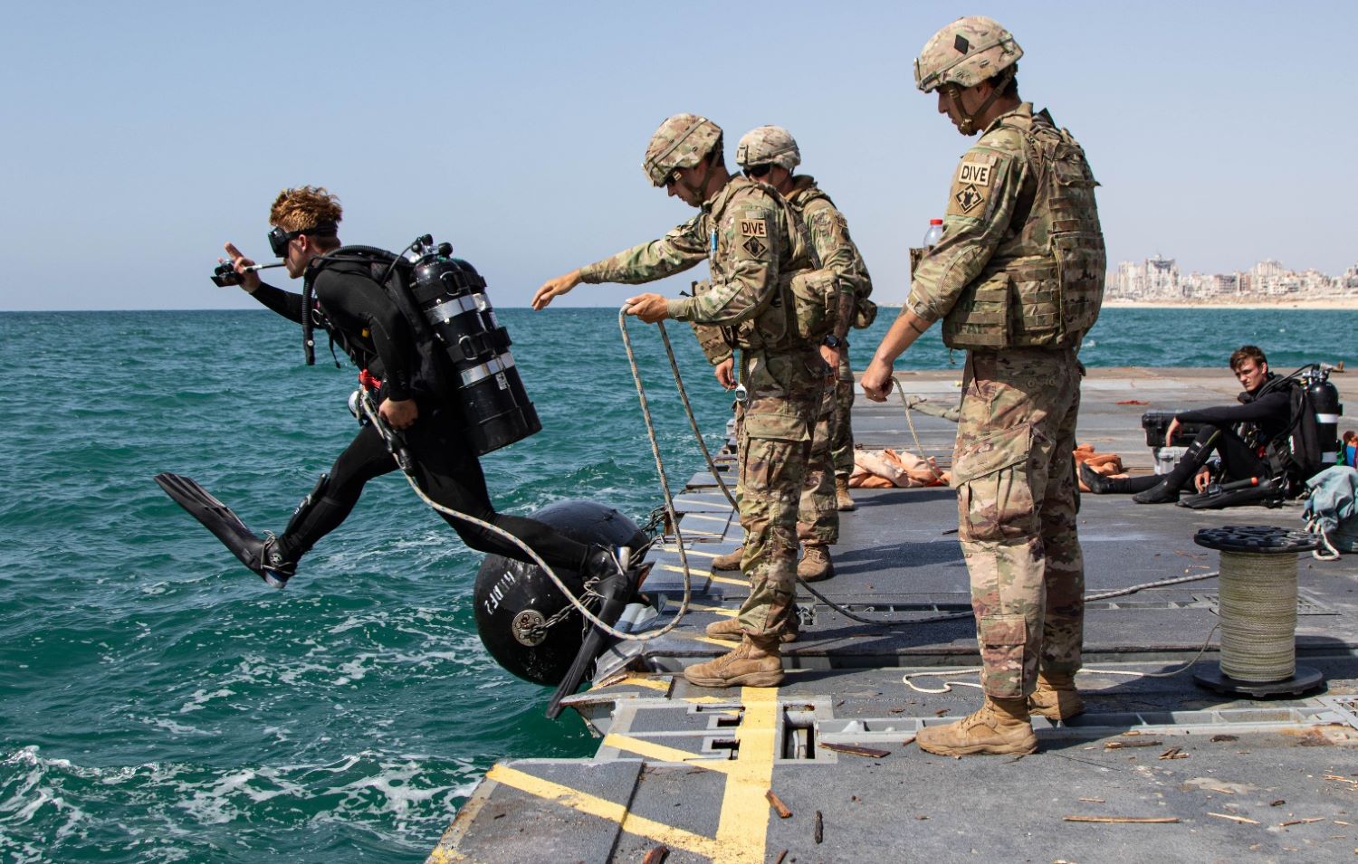 A soldier jumps into the water to dive