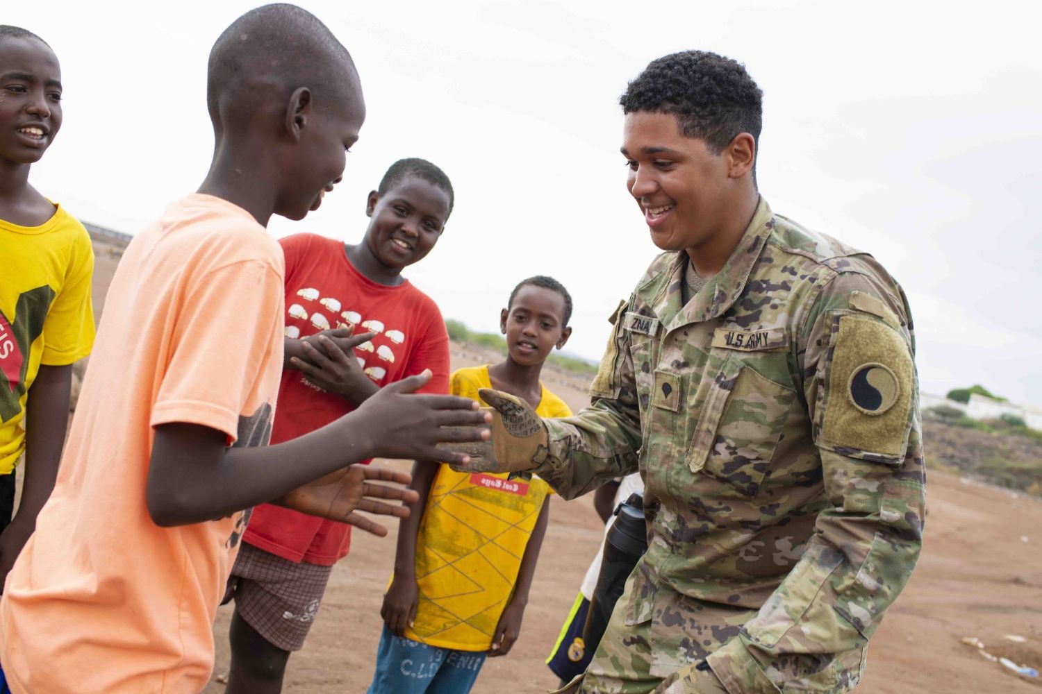 Soldier plays with local children