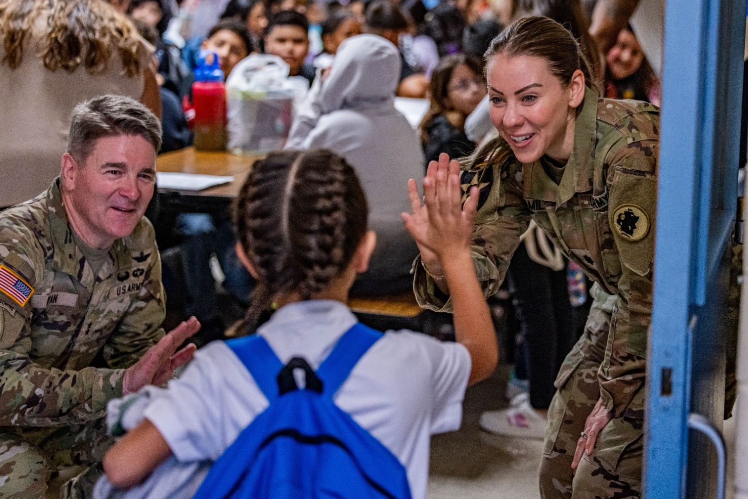 Soldiers welcomed a student on the first day of school at Booker T. Washington Elementary.