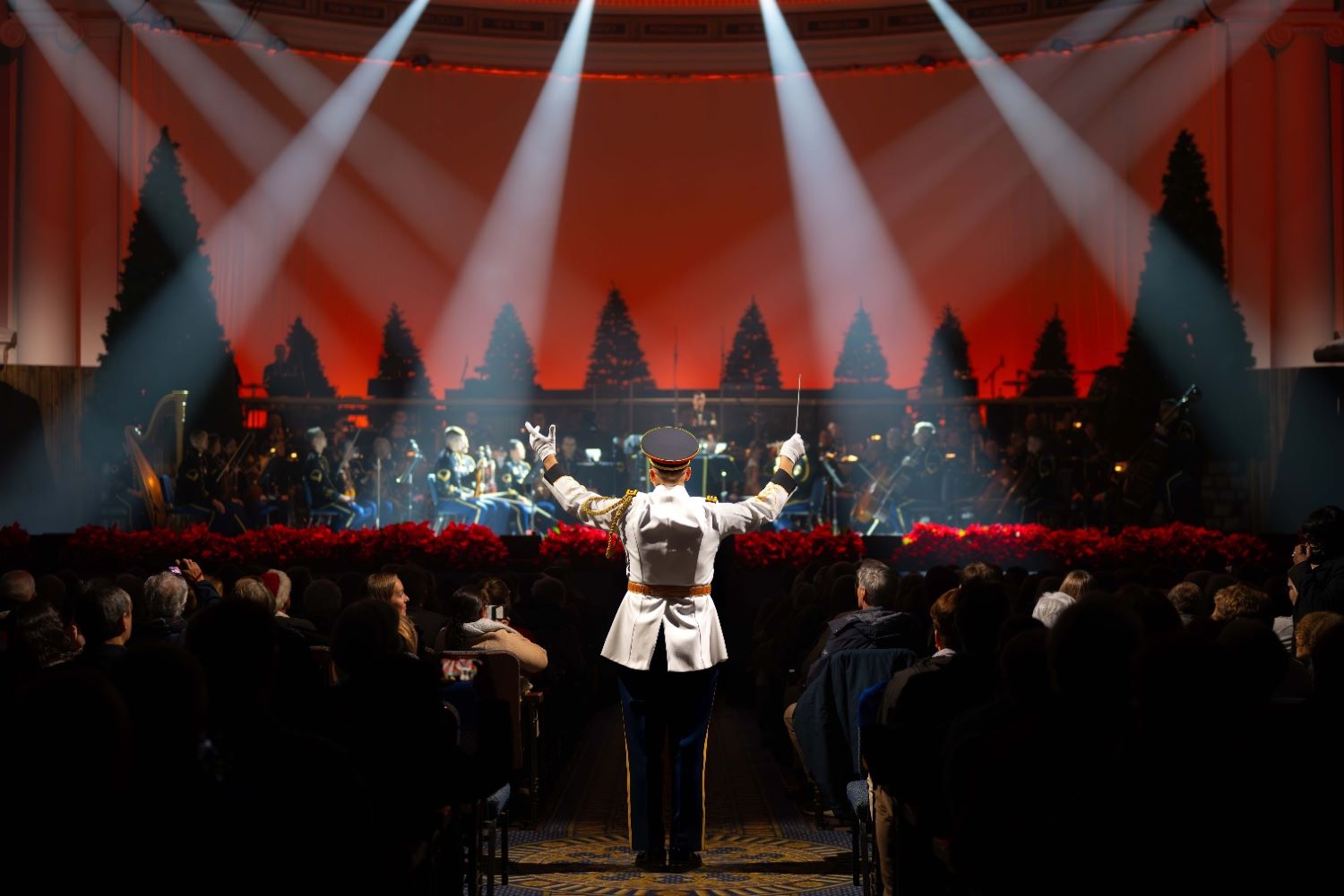 A conductor cues the U.S. Army Herald Trumpets