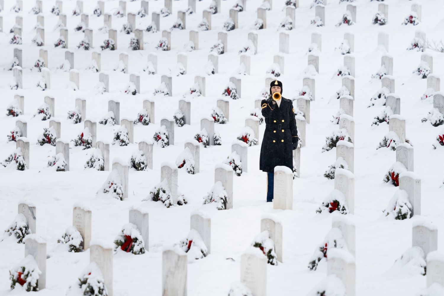 a bugler with The U.S. Army Band "Pershing's Own," sounded "Taps" at Arlington National Cemetery in Arlington
