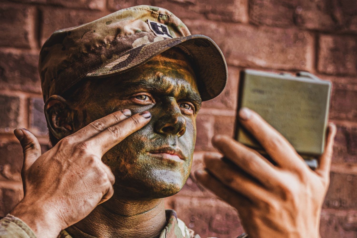 Capt. Moberly applies camouflage paint