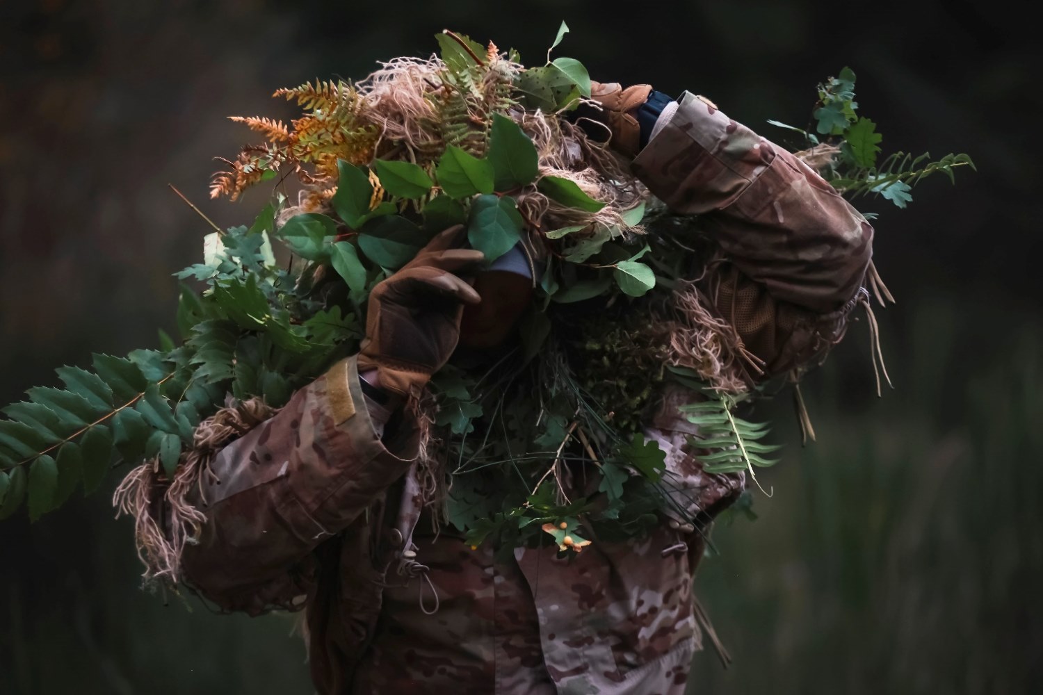 Army Spc. Drew Topp is seen exiting the wood line after completing an infiltration stalk lane