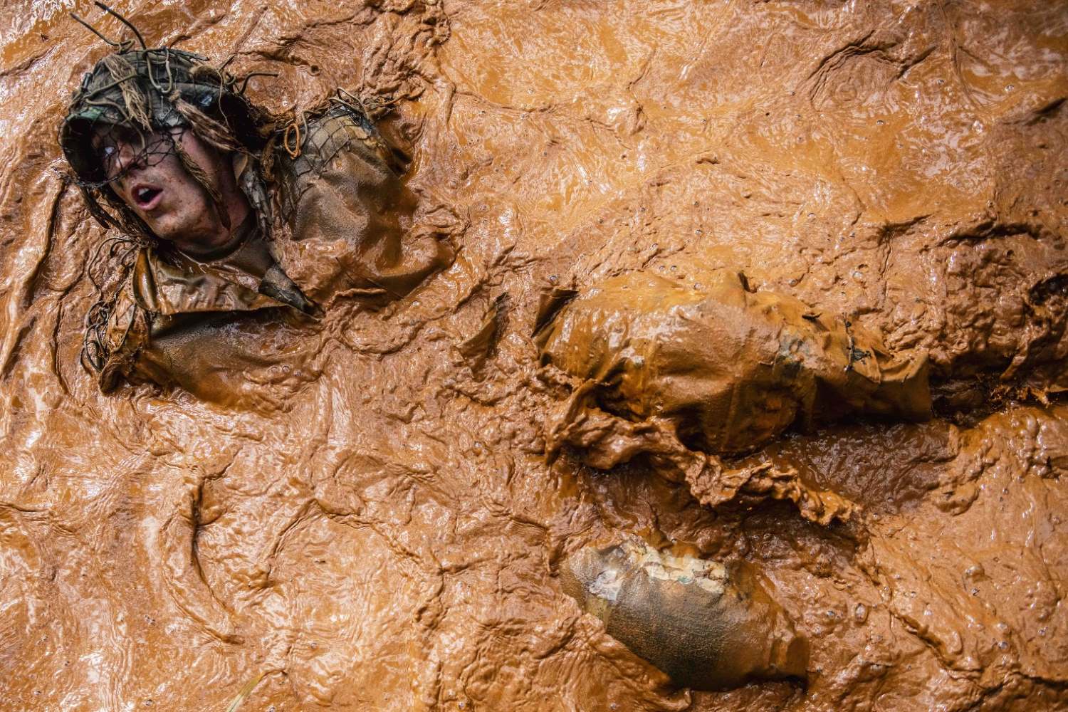A soldier takes part in a ghillie wash