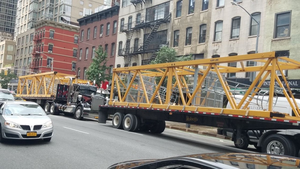 Omnibuild staff transport the crane equipment