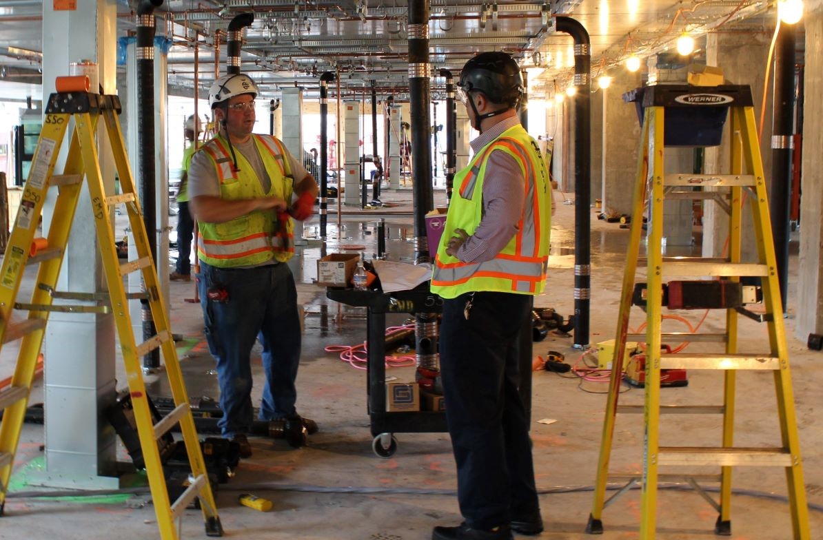 E.M Duggan supervisor collaborate with staff onsite