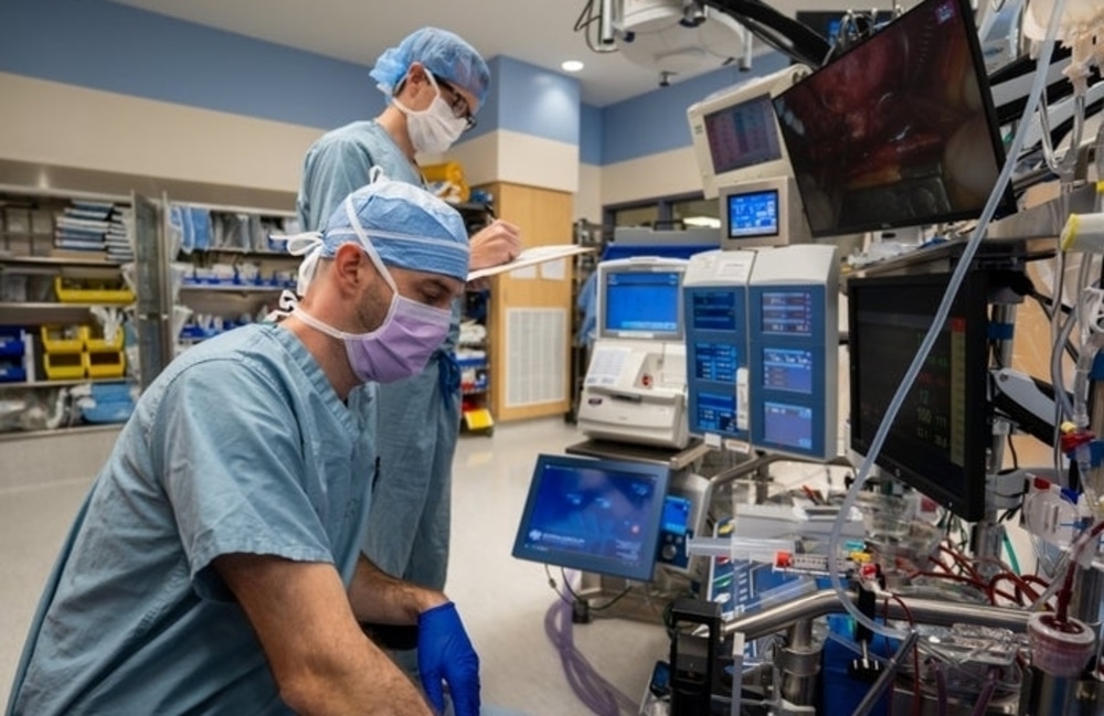 Ascension technicians check lab machine