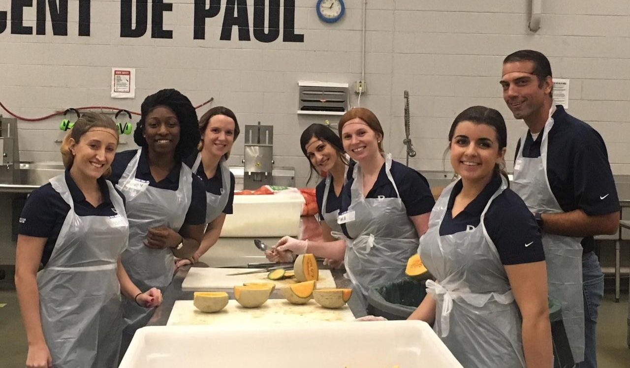 DEPCOM Power staff prepare meals at a volunteer day