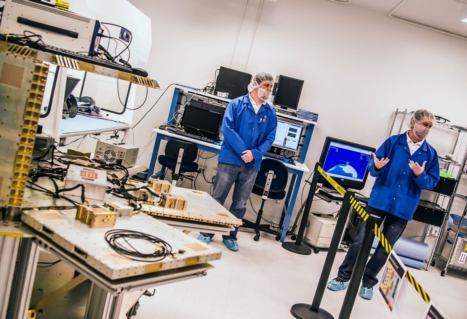Redwire Space engineers work with simulator devices in a lab