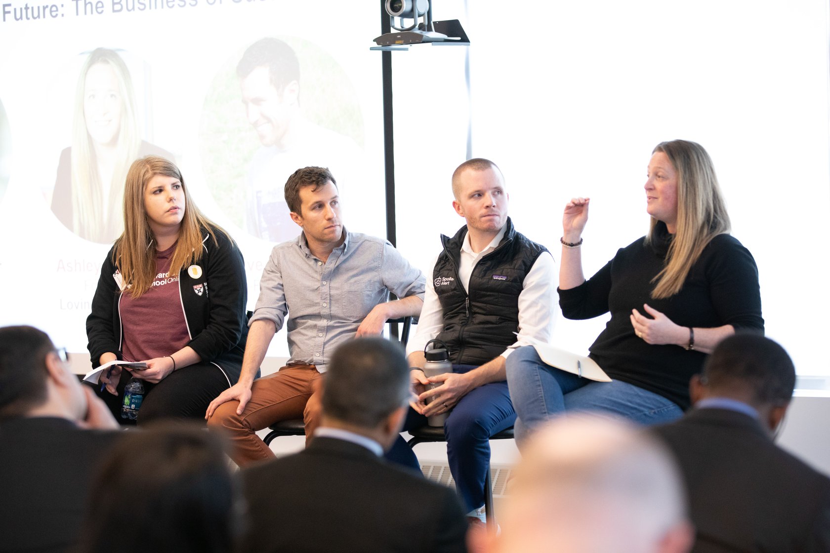 Harvard Business School staff discuss with entrepreneurs in a seminar