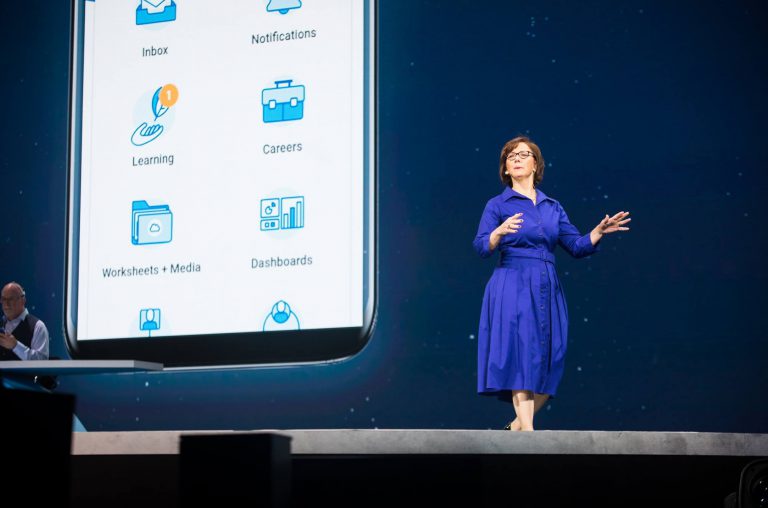 Workday staff on stage with product demo