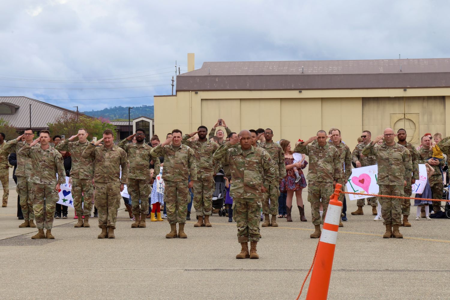 Members of the U.S. Air Force’s 9th Reconnaissance Wing salute as an aircraft carrying returning personnel touches down at Beale Air Force Base