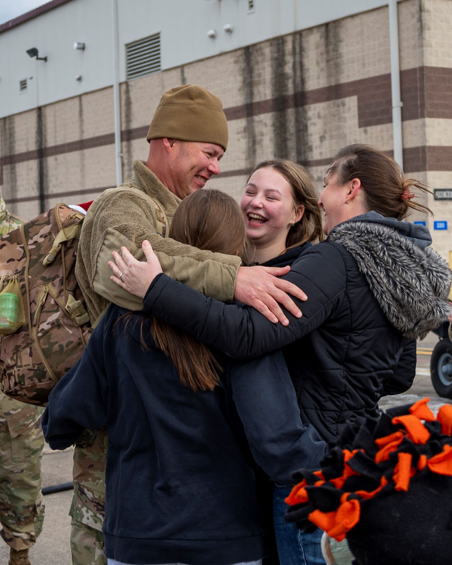 a soldier embraces his family
