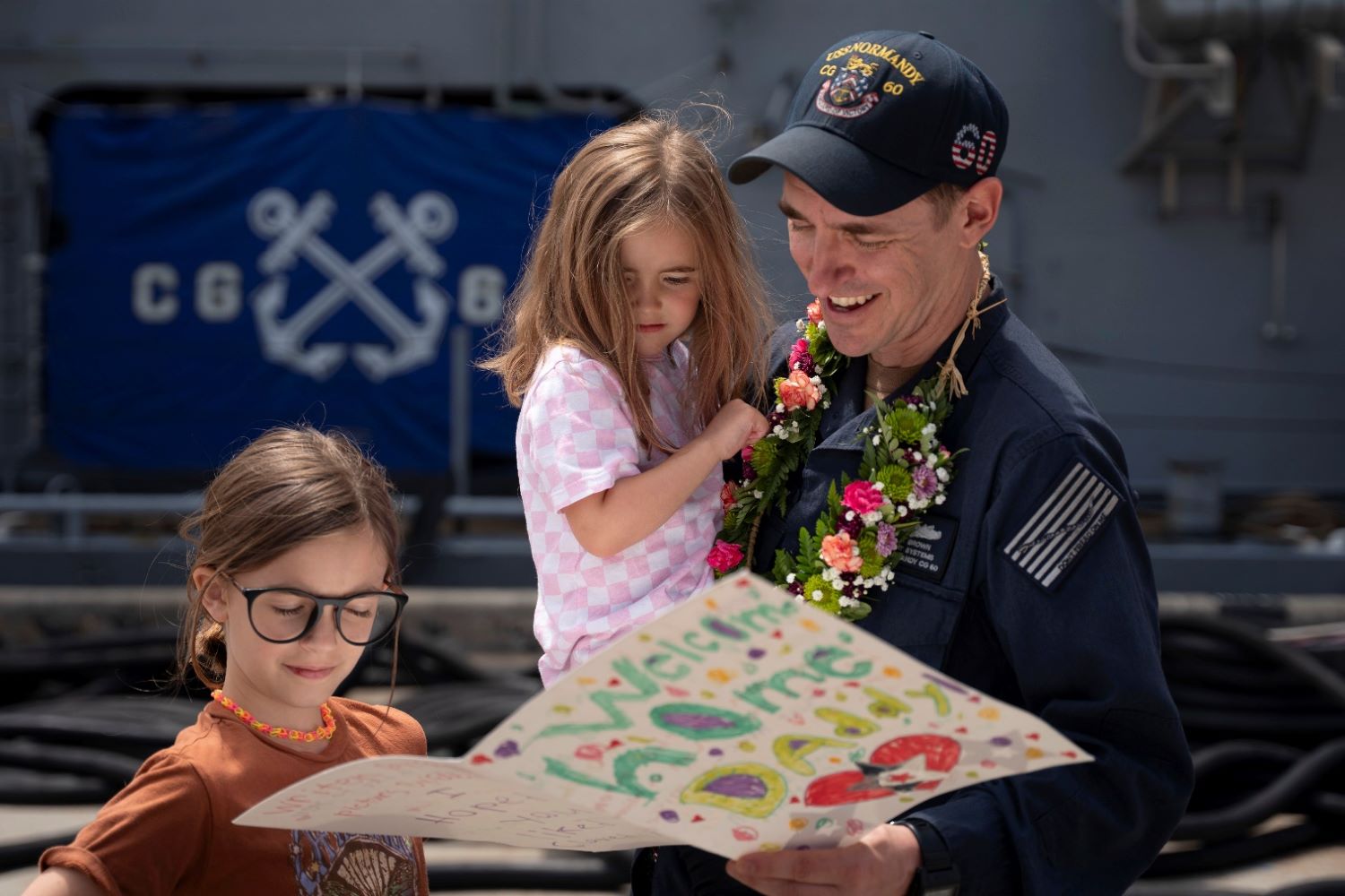 Navy Petty Officer 1st Class Adam Brown reads a heartfelt card from his family
