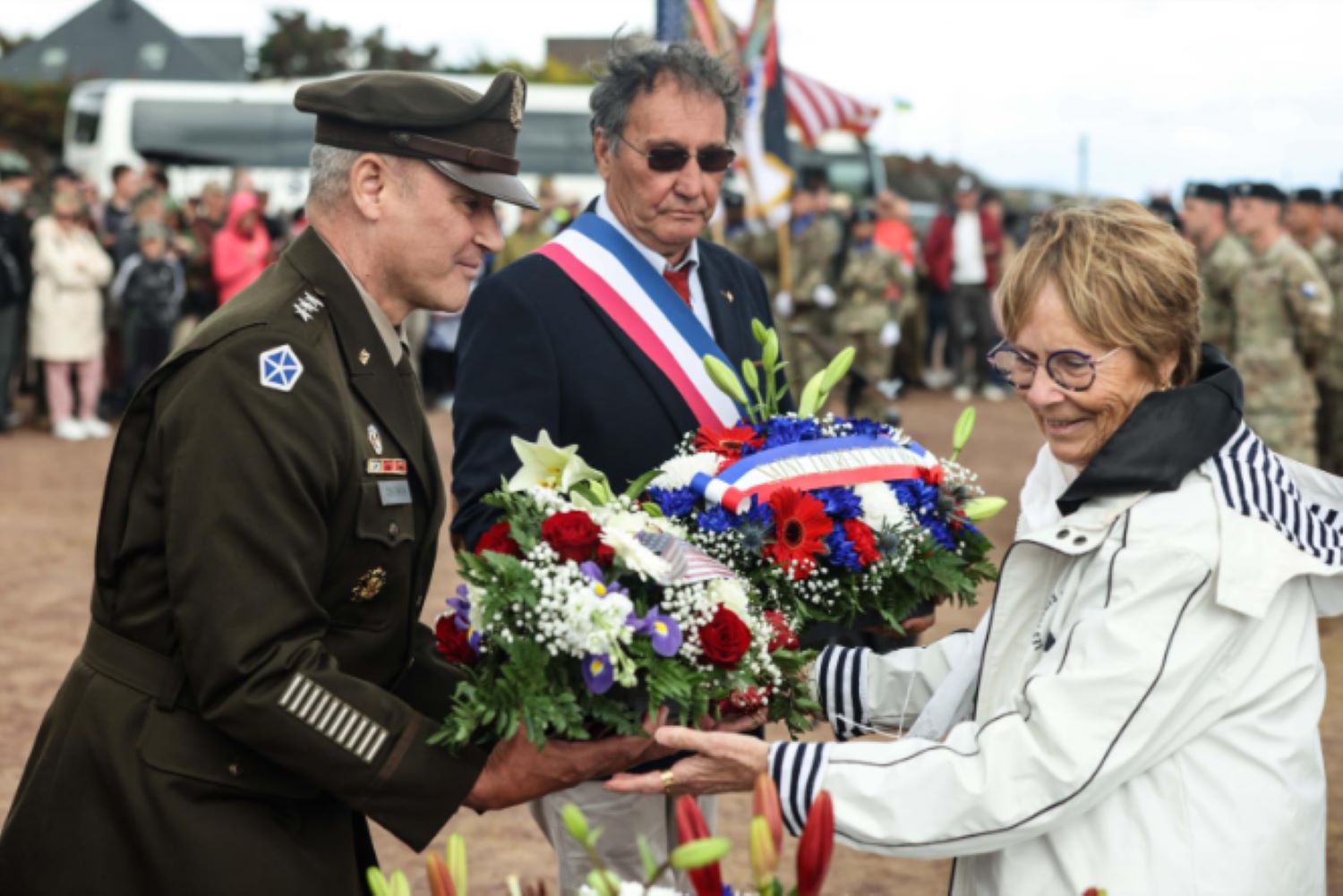 Army Lt. Gen. Charles Costanza, commanding general of V Corps, stands beside French officials