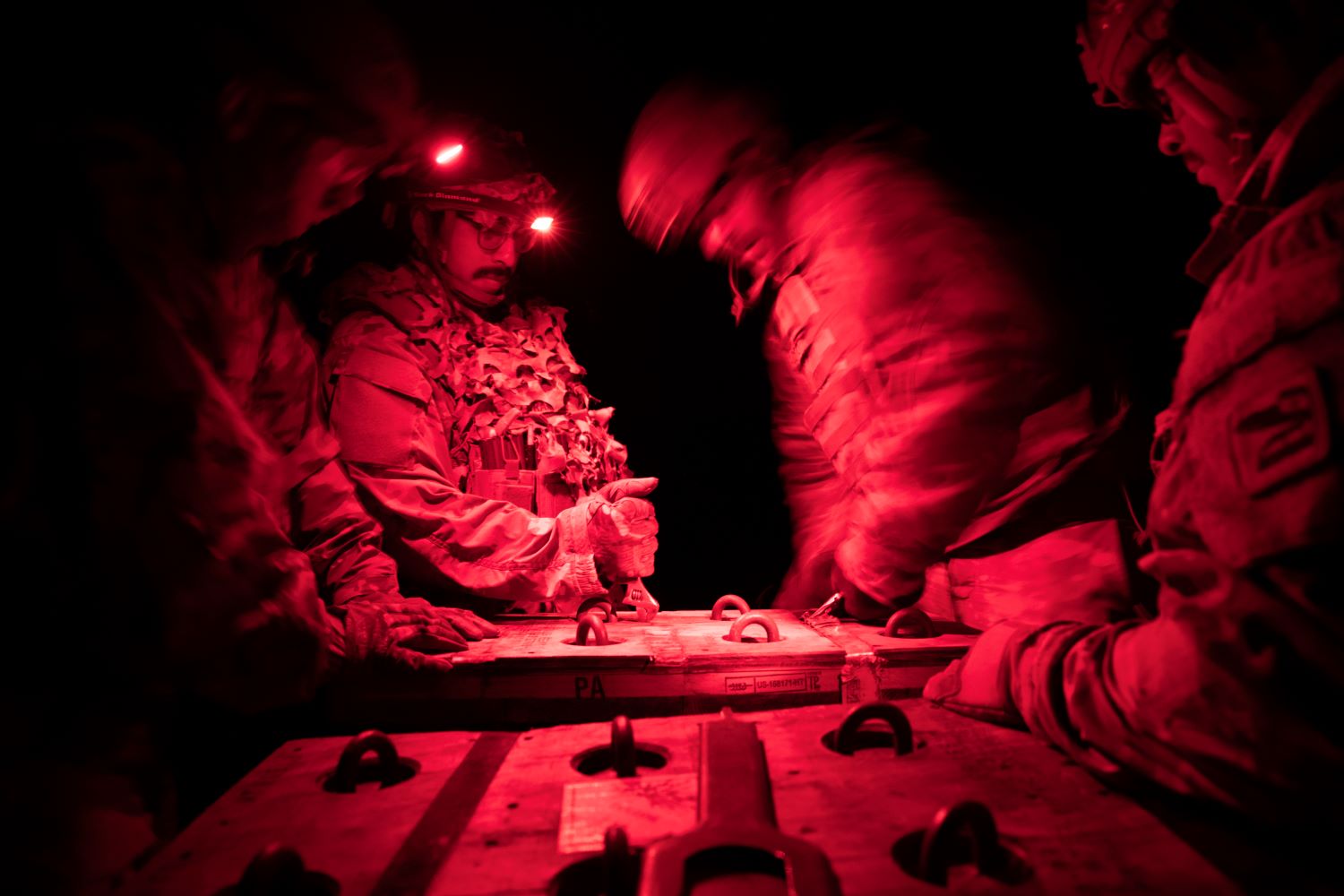 U.S. Army soldiers engaged in a live night fire exercise